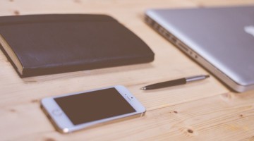 Book-Pan-Smartphone-And-Laptop-On-Wooden-Office-Desk